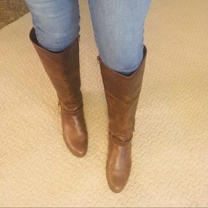 Brown leather boots with gold buckles